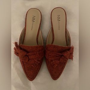 Red pointed toe flats with statement bow detail